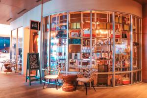 a store with chairs and a large glass display case at Paséa Hotel & Spa in Huntington Beach