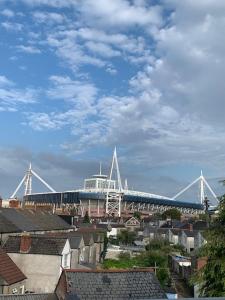 a stadium with a train in the middle of a city at City Center House, Cardiff, parking permit and garden in Cardiff