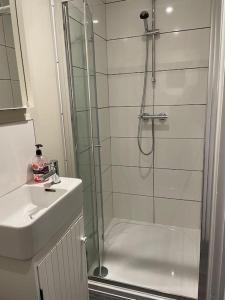 a bathroom with a glass shower and a sink at City Center House, Cardiff, parking permit and garden in Cardiff