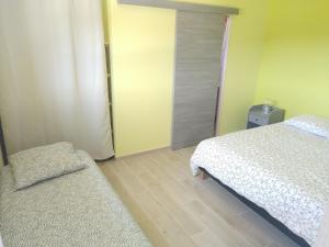 a bedroom with a bed and a chair and a door at eco nature, gite à la ferme in Vendays-Montalivet