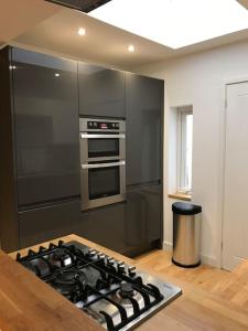 a kitchen with a stainless steel stove top oven at City Center House, Cardiff, parking permit and garden in Cardiff