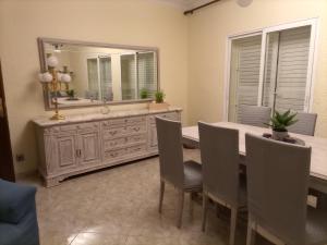 a dining room with a table and a large mirror at Casa Aymerich in Bellpuig