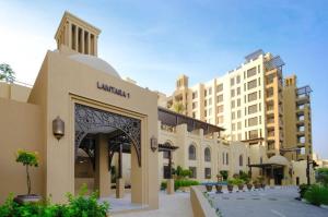 a building in a city with tall buildings at Madinat Jumeirah Living One bedroom apartment in Dubai