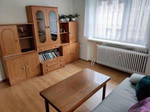a living room with wooden furniture and a coffee table at Priestranný dom v malebnom prostredí Liptova in Ružomberok
