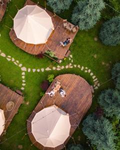 an overhead view of a deck with a table and umbrella at Valea Doftanei Glamping in Teşila