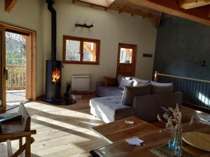 a living room with a couch and a fireplace at CHALET ARLETTE in Les Orres