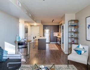 a living room with a couch and a table and a kitchen at National at Pentagon in Arlington