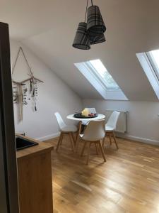 una cucina e una sala da pranzo con tavolo e lucernari. di Apartament Kendal a Dźwirzyno