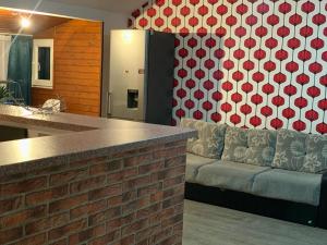 a kitchen with a couch next to a brick wall at Apartament in regim hotelier in Timişoara