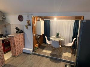 cocina pequeña y comedor con mesa y sillas en Apartament in regim hotelier en Timisoara