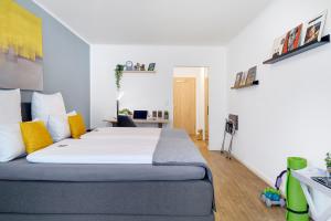a bedroom with a large bed with yellow pillows at Hotel Marktterrassen in Hennef