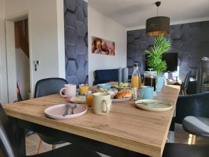 a dining room table with breakfast foods on it at Modernes behagliches Haus mit Kamin, Terrasse und Garten in Magdeburg