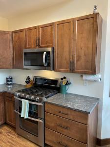 a kitchen with a stove and a microwave at Family Friendly, Pet Friendly, New Build, 20 mi to Breckenridge - Lamplighter Lodge in Fairplay