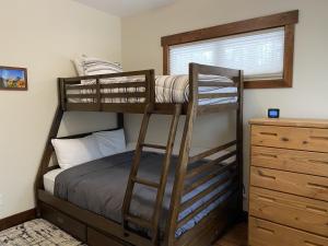a bedroom with two bunk beds and a dresser at Family Friendly, Pet Friendly, New Build, 20 mi to Breckenridge - Lamplighter Lodge in Fairplay