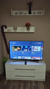 a flat screen tv sitting on top of a dresser at Cozy home Bujorilor in Timişoara