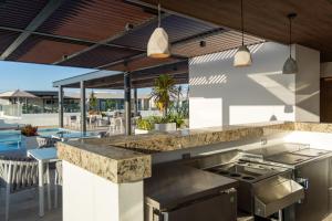 an outdoor kitchen with a counter and a patio at New & Equipped Apartment Steps From The Beach With Pool Jacuzzi By Yeah in Playa del Carmen