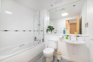 La salle de bains blanche est pourvue de toilettes et d'un lavabo. dans l'établissement Bannermill Place Lodge ✪ Grampian Lettings Ltd, à Aberdeen