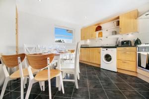 a kitchen and dining room with a table and chairs at Bannermill Place Lodge ✪ Grampian Lettings Ltd in Aberdeen