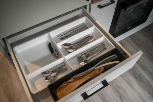 a drawer with silver utensils in a kitchen at Batorego 16 Yellow Prywatne mieszkanie 300m od Metro Pole Mokotowskie i SGH in Warsaw