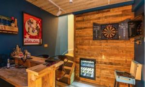 Zimmer mit einem Tisch und einer Dartscheibe an der Wand in der Unterkunft 5 Star Luxury Woodland Retreat Sleeps 12 Hot tub Sauna in Clapton in Gordano