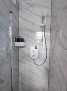 a shower with a shower head in a bathroom at STUNNING STUDIO In NORTH LONDON - VICTORIA LINE in London