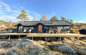 a house with a deck with chairs on it at 3 Bedroom Pet Friendly Home In Eggedal in Eggedal