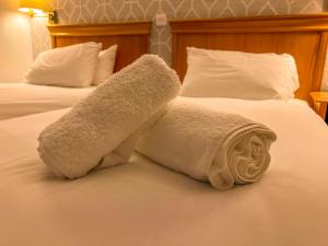 two towels on a bed in a hotel room at The Red Lion Hotel in Spalding
