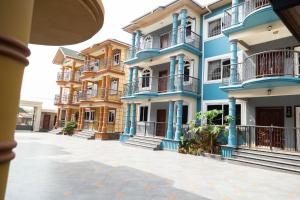 a row of apartment buildings with blue trim at De Chateau Paradise in Accra