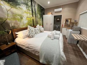 a bedroom with a bed and a kitchen at Mountain Trails Accommodation in George