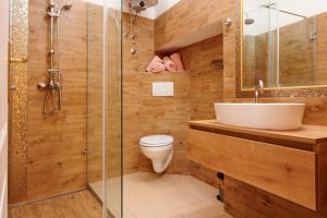 a bathroom with a toilet and a sink and a shower at Palace Derossi in Trogir +54 photos