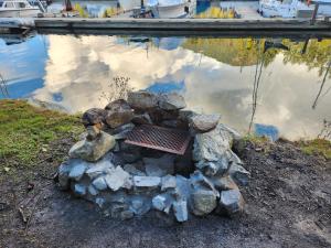 a statue of a fire pit next to a body of water at Sunshine Coast Resort in Madeira Park