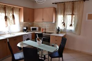 a kitchen with a table and chairs in a kitchen at Villa La Mer in Skala Potamias