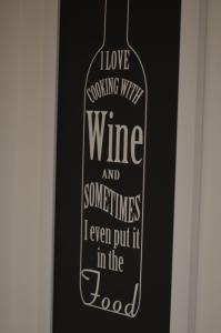 a picture of a bottle of wine on a door at Apartman N&A in Novi Sad