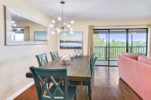 a dining room with a table and chairs and a couch at Sea Shell 24 in Clearwater Beach