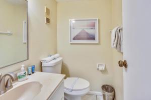 a bathroom with a toilet and a sink and a mirror at Sea Shell 24 in Clearwater Beach