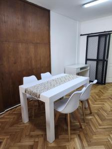 a white table and chairs in a room at Obelisco Deptos in Buenos Aires