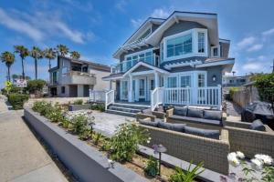 a large house with a blue at Luxury Ocean Views & Steps To The Sand - Tower 36 Upper Condo Unit in Carlsbad