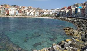 a view of a beach with buildings and the water at Rua GALICIA in A Guarda