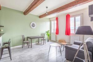 a living room with a couch and a table at Hostel Ambassade Bretonne Vieux-Port in Marseille