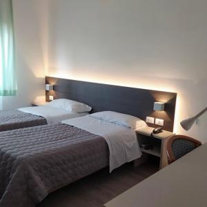 Postel nebo postele na pokoji v ubytování Hotel Friuli