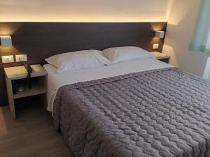 Postel nebo postele na pokoji v ubytování Hotel Friuli
