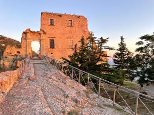an old brick building on a hill with a bridge at Residenza Matilde in Fiumefreddo Bruzio