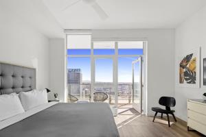 a bedroom with a bed and a large window at Level Los Angeles - Downtown Flower in Los Angeles +58 photos