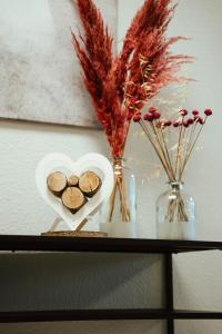 a table with a heart shaped bowl of cookies and flowers at Ferienwohnung Katharinenberg 