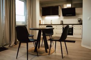 a kitchen with a table and four chairs in it at Ferienwohnung Katharinenberg in Katharinenberg
