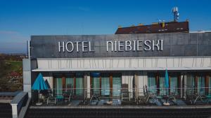 a hotel with tables and chairs on a balcony at Niebieski Art Hotel & Spa in Kraków