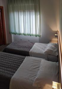 Postel nebo postele na pokoji v ubytování Hotel Friuli