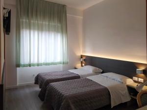 Postel nebo postele na pokoji v ubytování Hotel Friuli