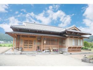 a japanese house with a dog in front of it at Villa MITORE-YA - Vacation STAY 13536 in Takayama