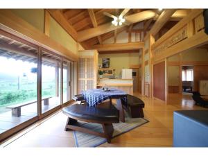 a dining room with a table and a kitchen at Villa MITORE-YA - Vacation STAY 13536 in Takayama